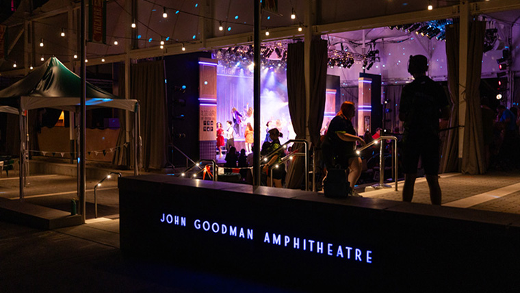 Night photo looking into tent during show in the John Goodman Amphitheatre